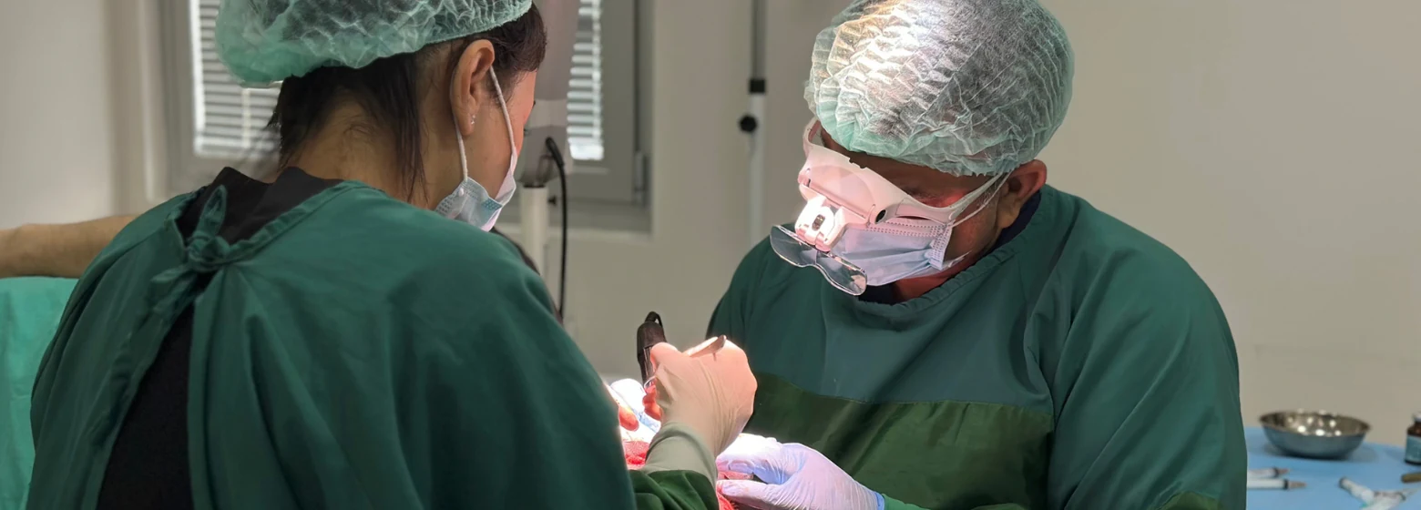 Dr. Arslan Musbeh using a precision punch instrument on the donor area during a hair transplant session at Hairmedico